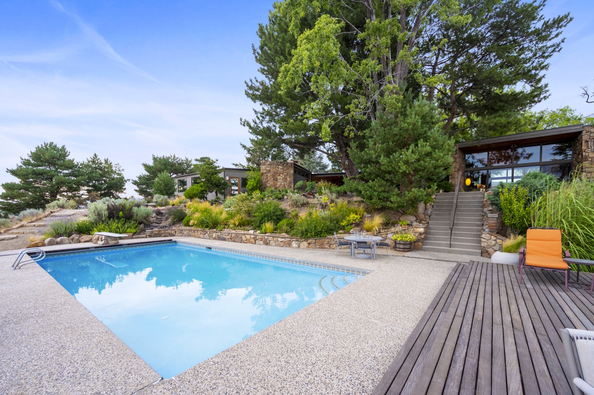 In-ground diving pool with city and mountain views